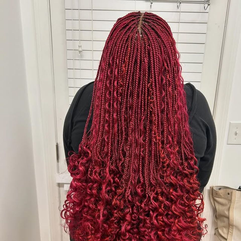Long burgundy red box braids with curly ends after a braiding service in Los Angeles CA