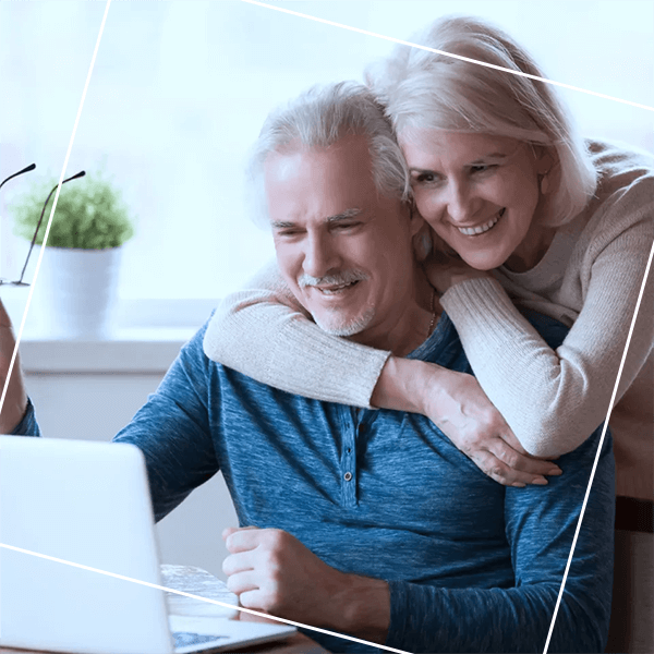 Old couple looking at laptop