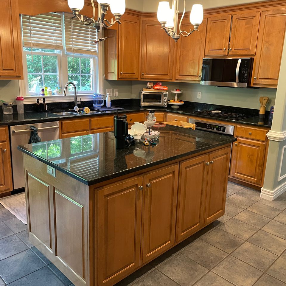Clean kitchen with granite island and stainless steel appliances after a house cleaning service in Virginia Beach VA
