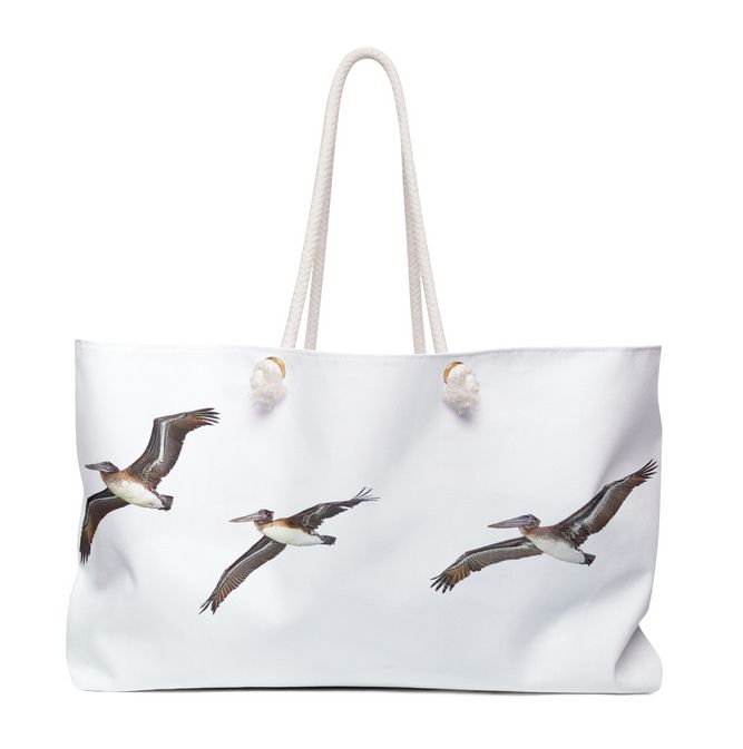 Brown Pelican weekender Bag portraying the beauty of the pelicans as they fly acros the sky.
