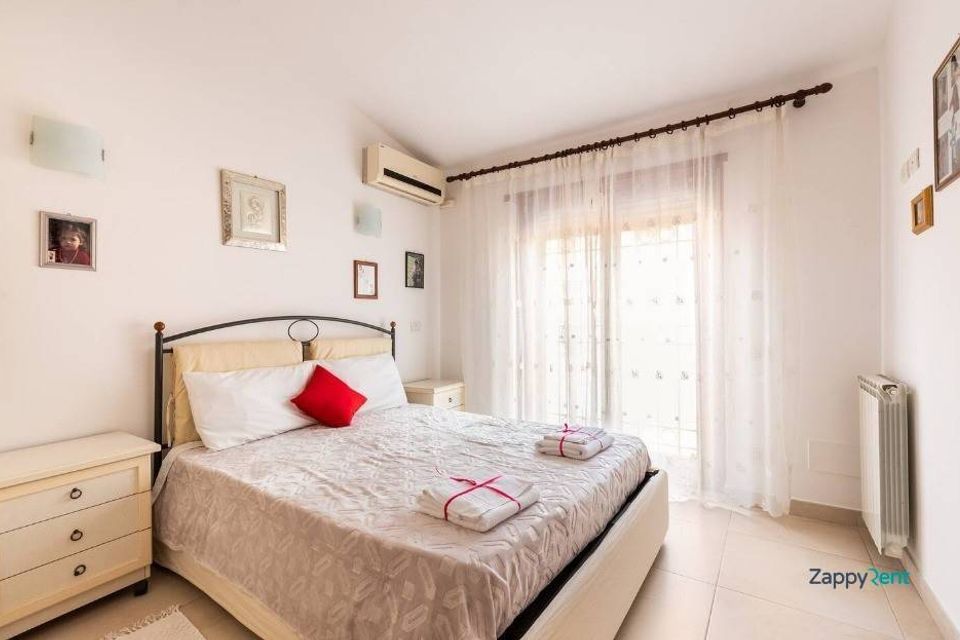 Spacious double bedroom with private bathroom at Rome vacation home rental in Axa-Palocco, Italy
