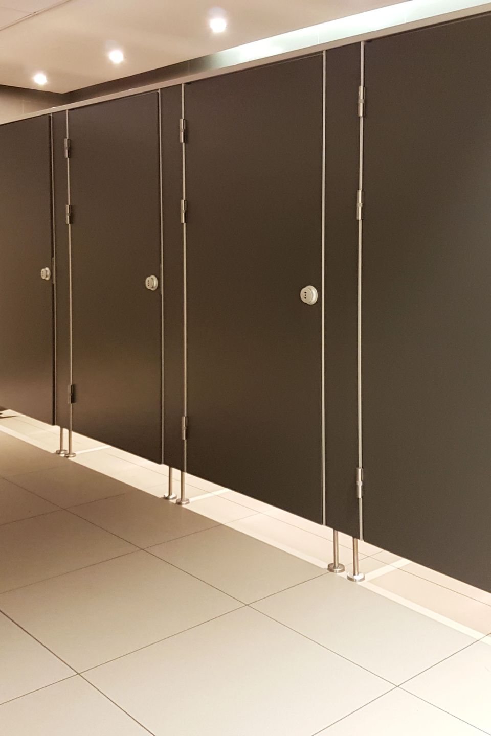 Vistacreate 245221742 stock photo doors public toilet interior beige tones place need people restroom