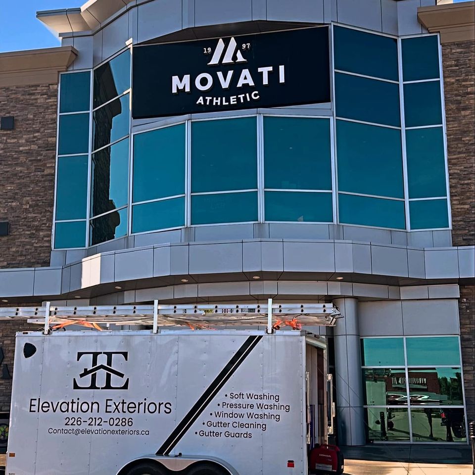 Elevation Exteriors trailer parked outside a fitness club for a commercial window washing job