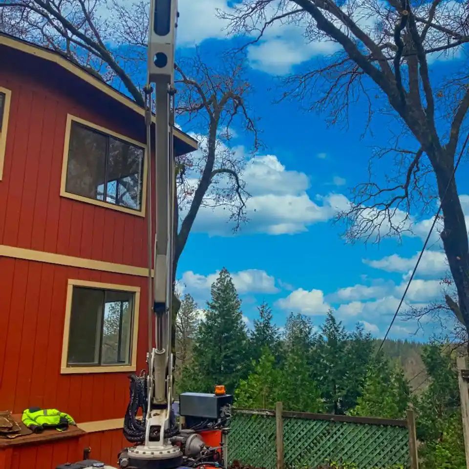 Aerial lift equipment operated by a Lyons Tree Service expert for high-altitude tree removal in Rocklin, CA, ensuring safe operations over rooftops and power lines.