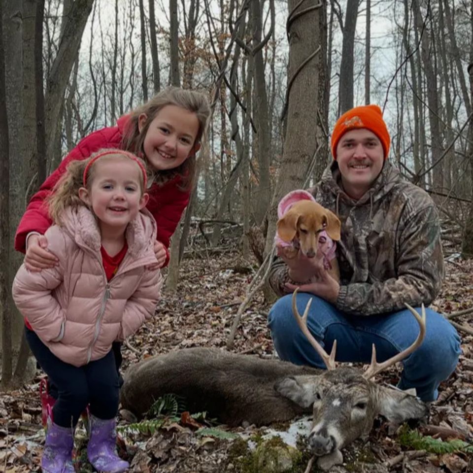 Kyle Smith with his family and the 6-point buck he harvested