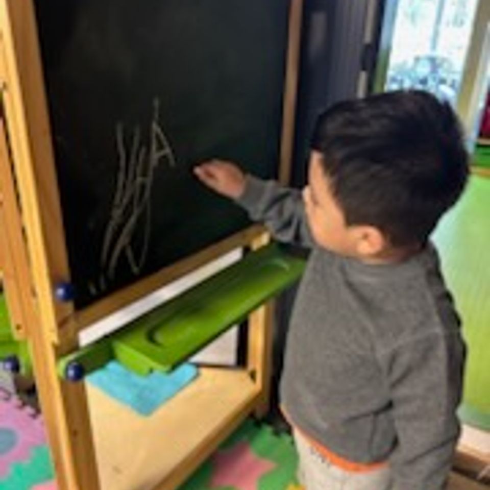 Boy writing on board brendas family daycare