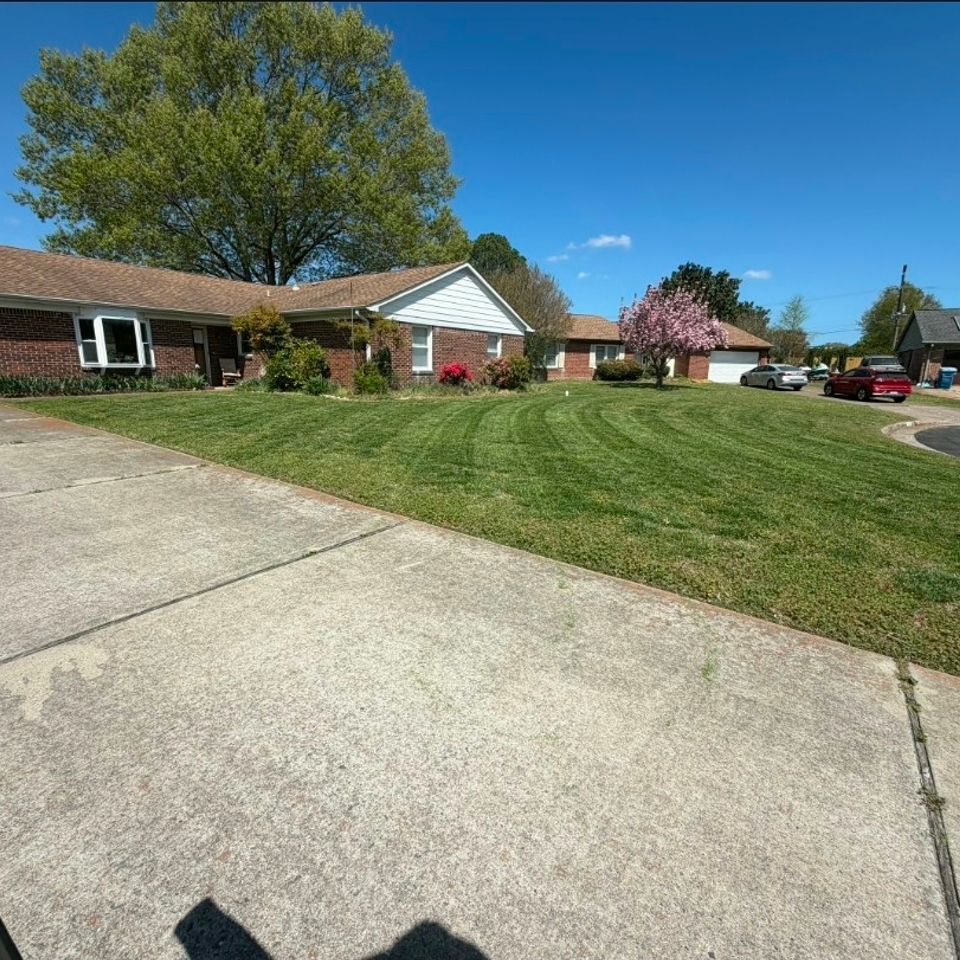 Wide angle shot of a clients front grass beautifully cut, done by Get A Mow On Lawn Care LLC of Chesapeake VA