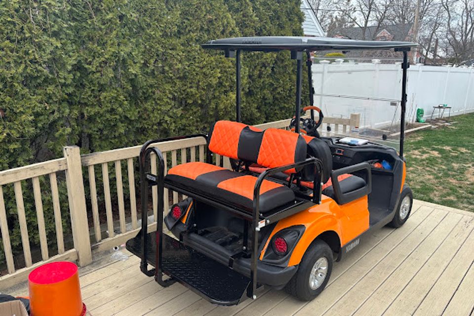 Back view of an orange golf cart rental from Mad Dog Golf Cart Rentals in Locust Lake PA