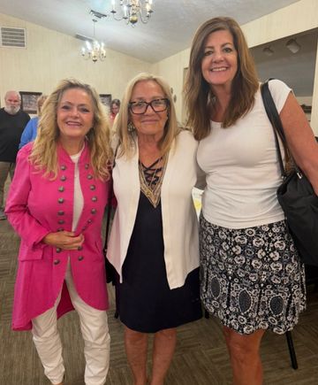Three women posing together at a Mahoning Valley event.