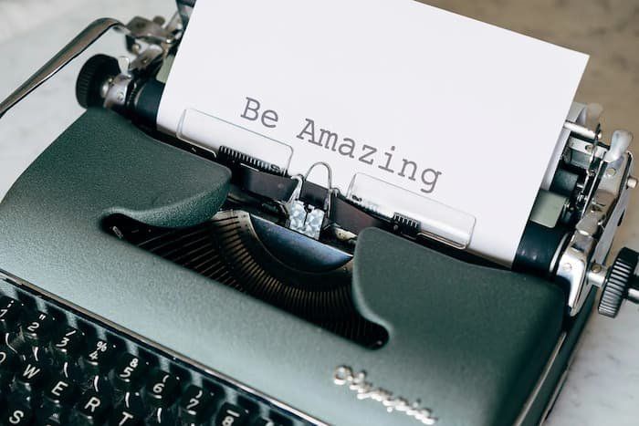 Typewriter with a piece of paper coming out saying "Be Amazing." 