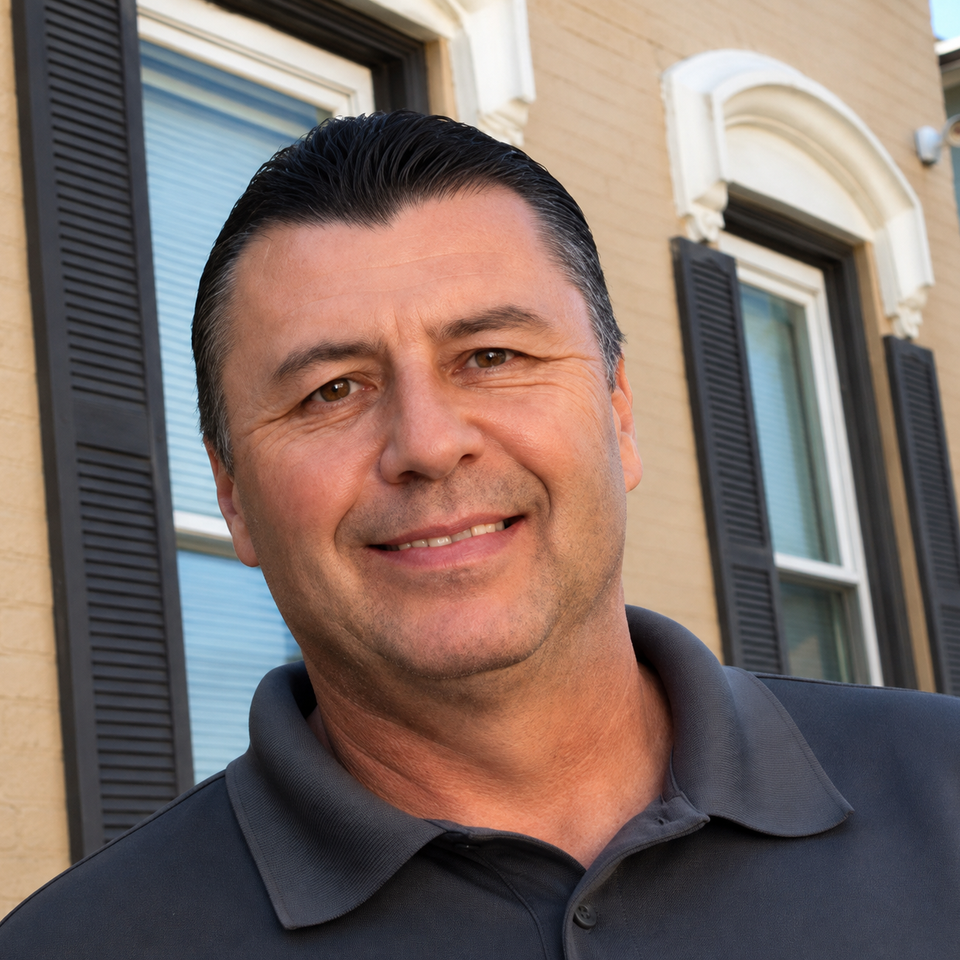 Smiling man by beige brick facade