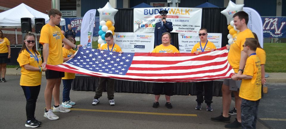 Participants holding the American flag during the opening ceremony of the Down Syndrome Association of the Valley Buddy Walk.