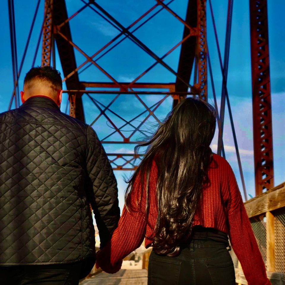 Close-up drone shot of a couple walking in a bridge | Boise Aerial Drone Photography