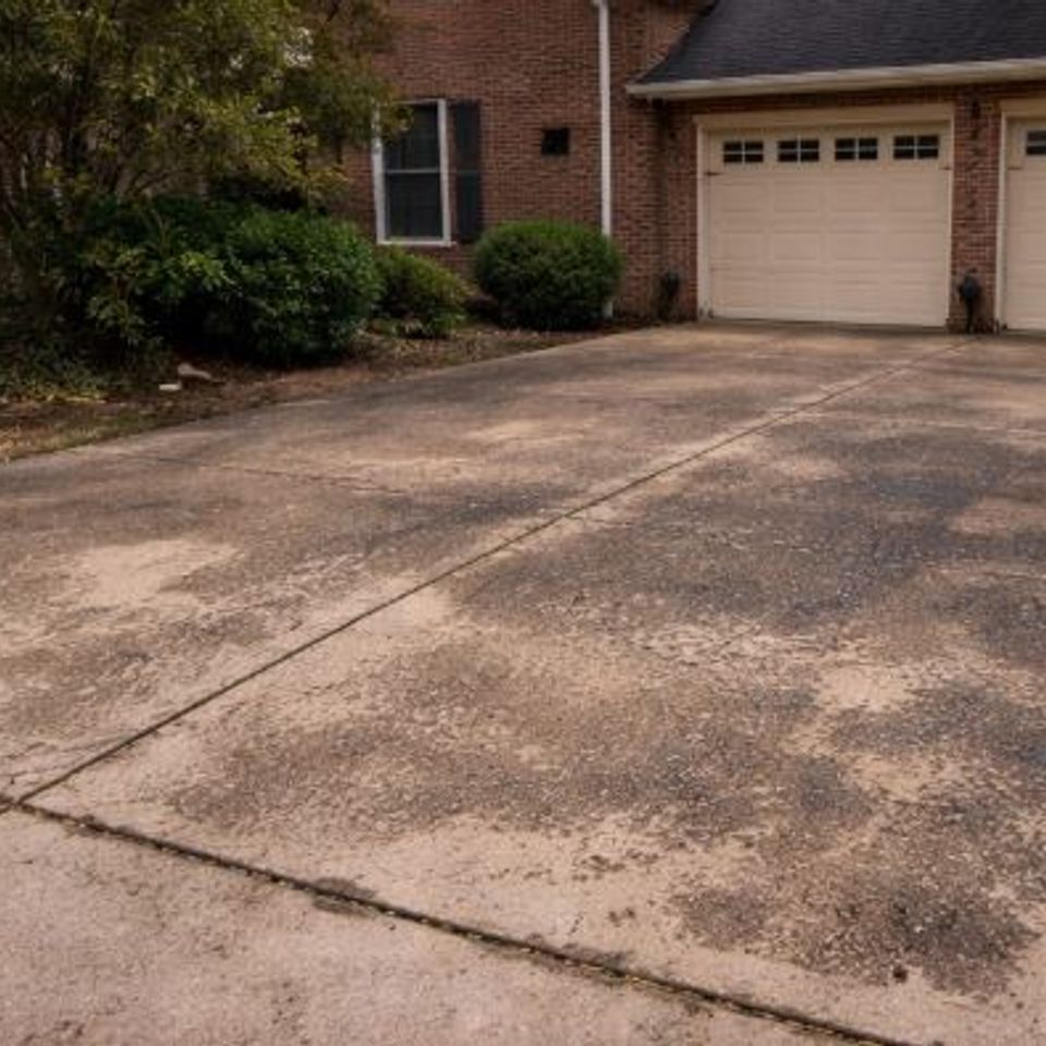 Before photo of a stained driveway