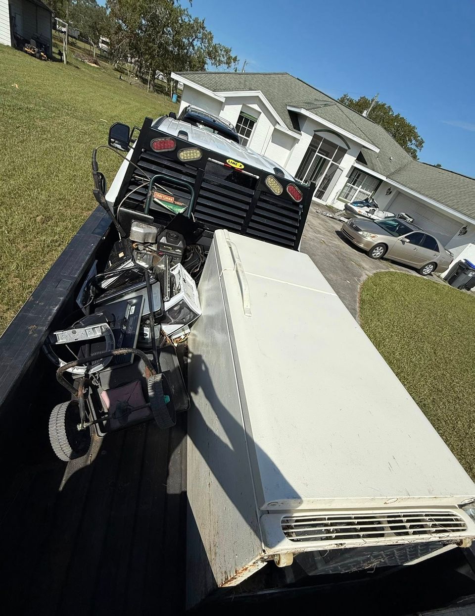 A refrigerator in the back of the JNJ Hauling Solutions truck prepared for transportation