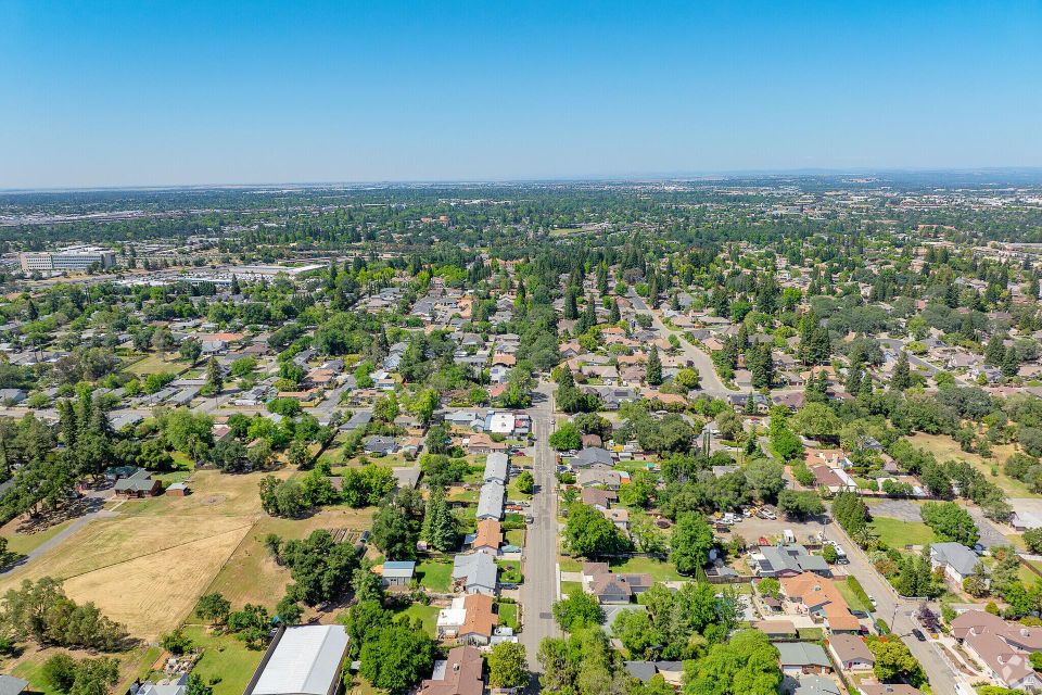Aerial drone view of the residential tree canopy in Citrus Heights, CA, where Above It All Tree Care provides expert arborist services.