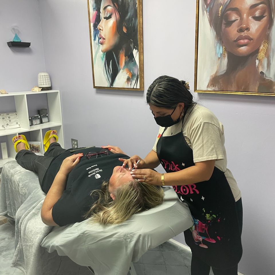 A technician at Nail Lovers working with a client
