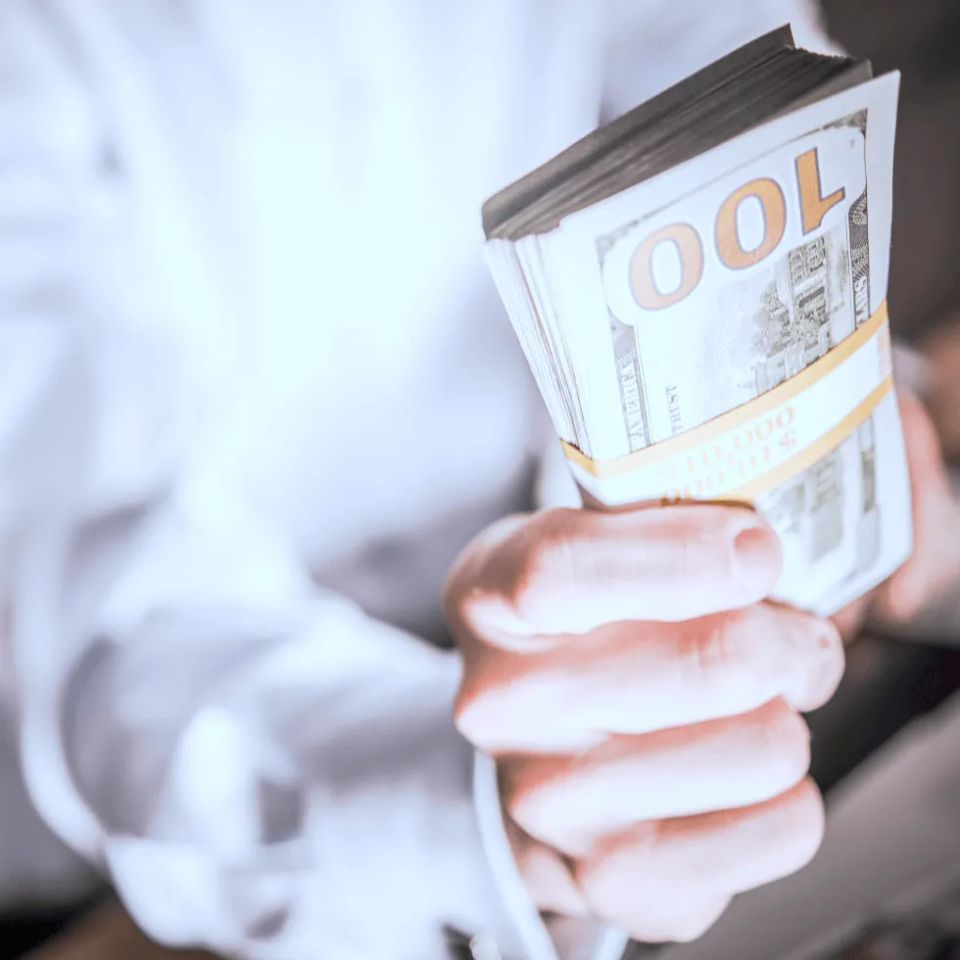 Businessman holding stack of cash