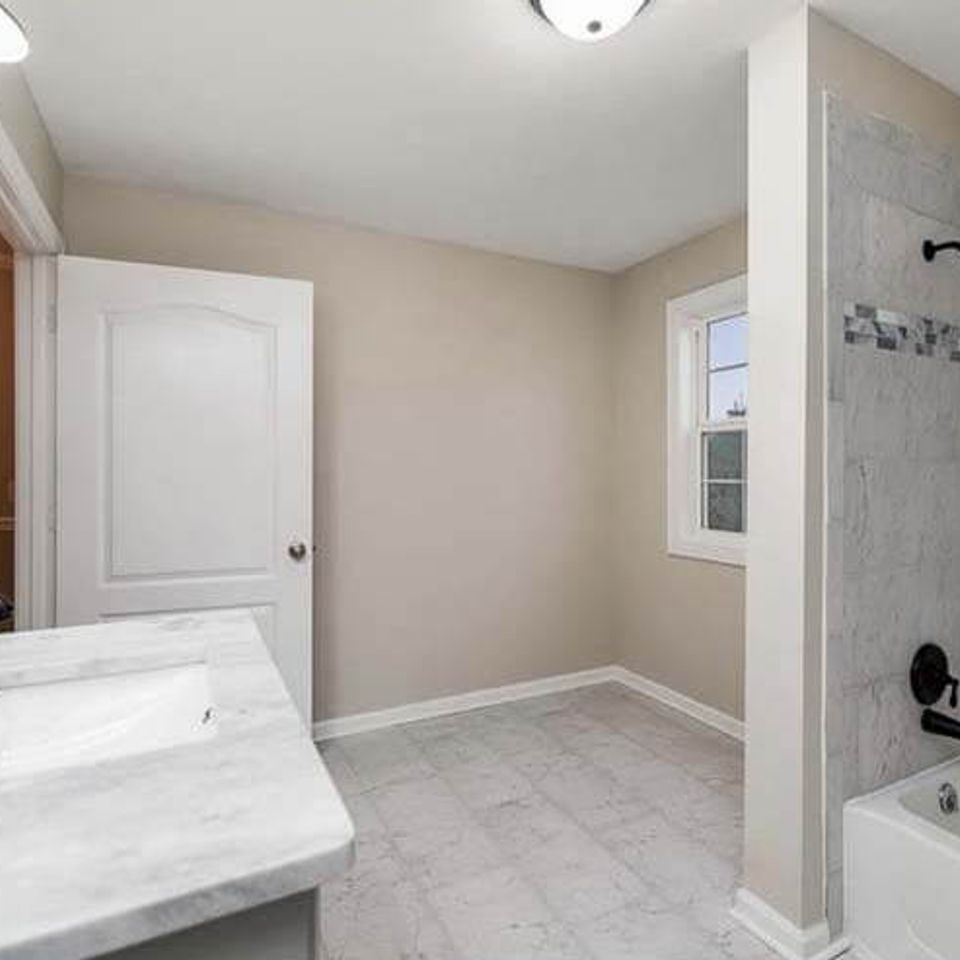 Stylish bathroom remodel with glass shower enclosure and tile flooring in Knoxville TN