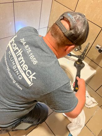 Kenny working on fixing a toilet commerial