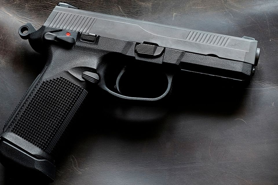 Bigstock handguns or pistols on leather 437762600