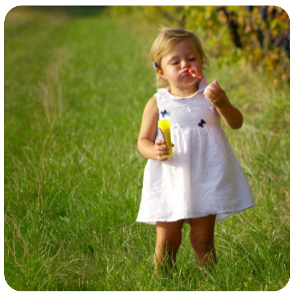 2year old girl outside blowing bubbles