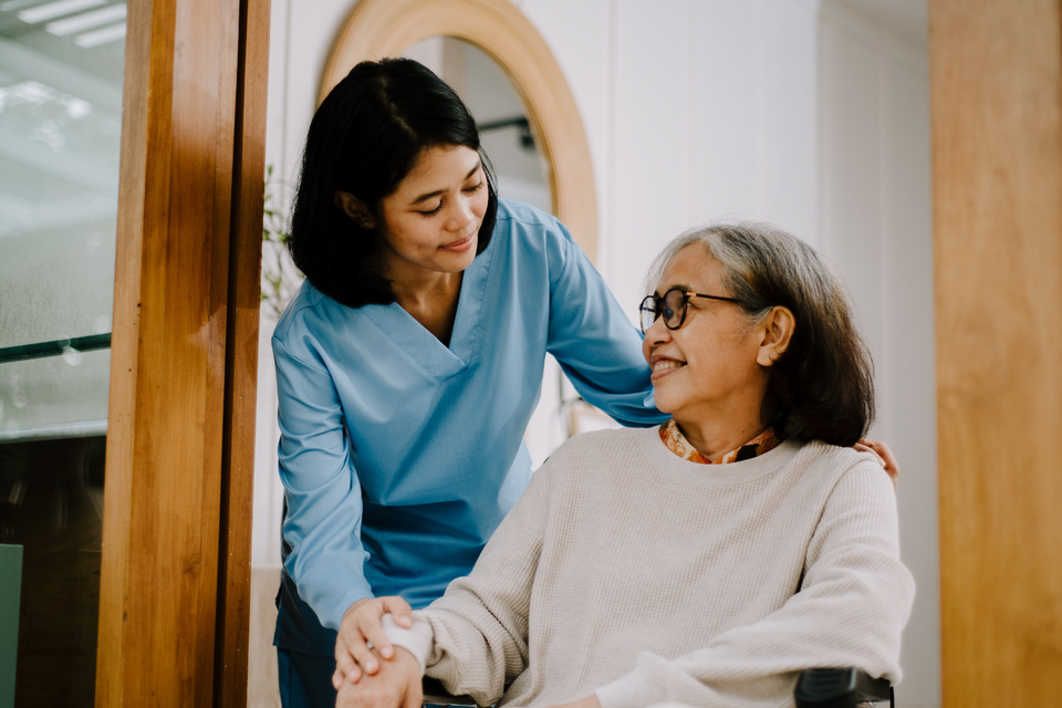 Carer providing assistance to patient