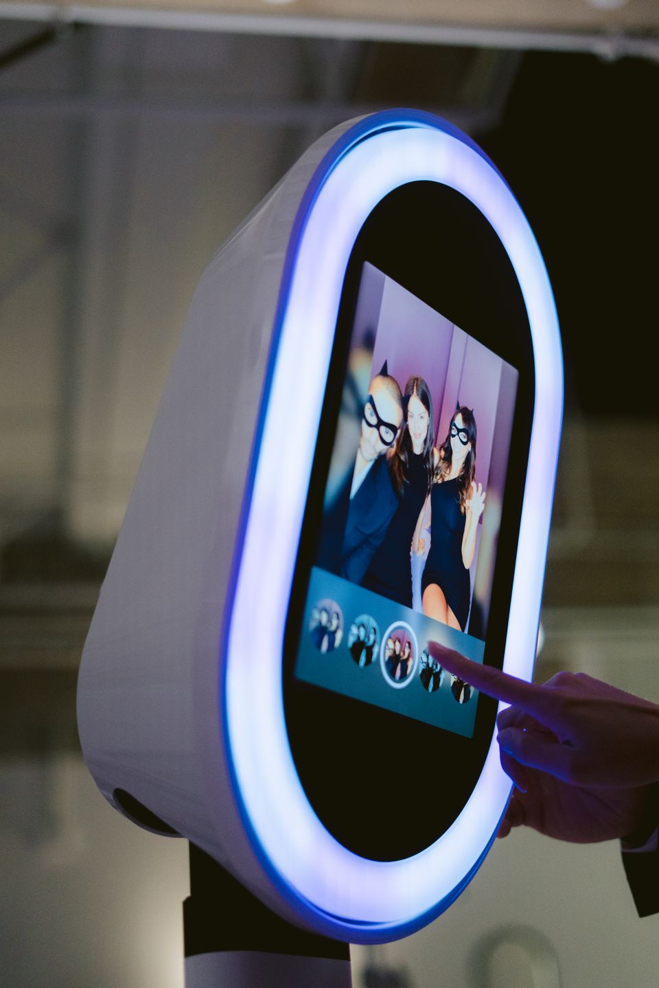 Guest selecting photos on a modern photo booth screen.