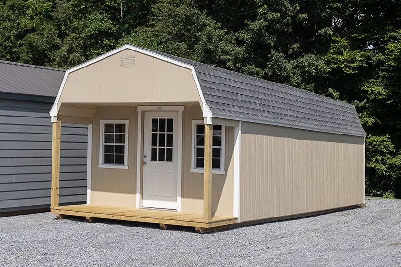 Tan Dutch cabin with front porch, windows and shingle gambrel roof in Knoxville TN