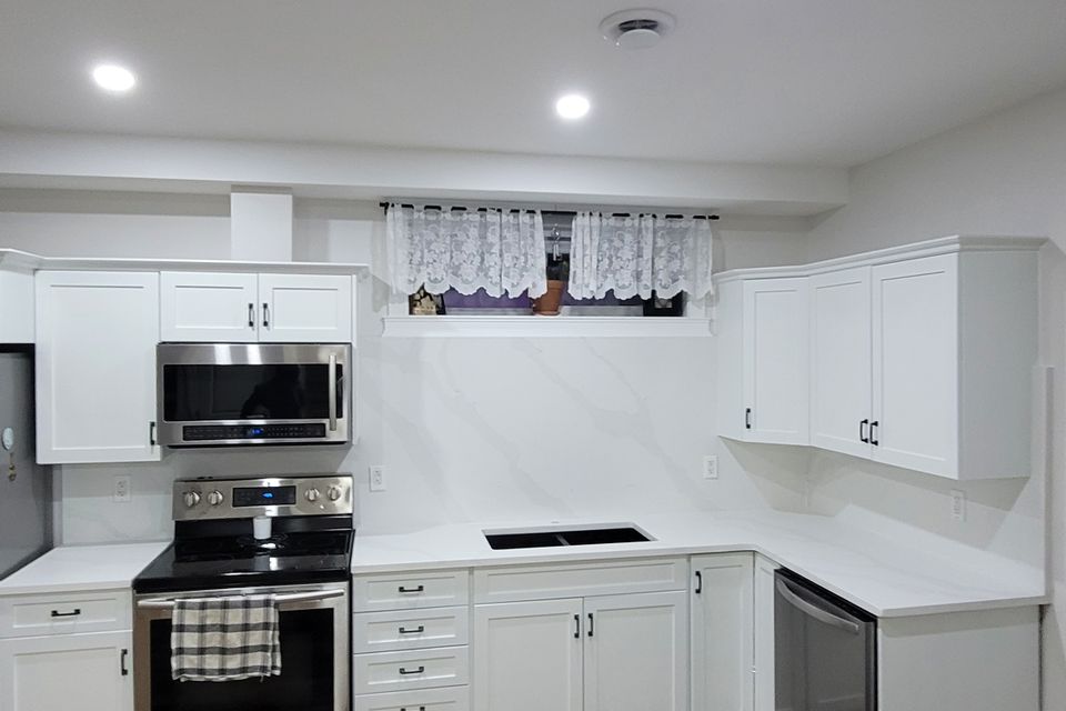 Bright kitchen with white countertop and tables