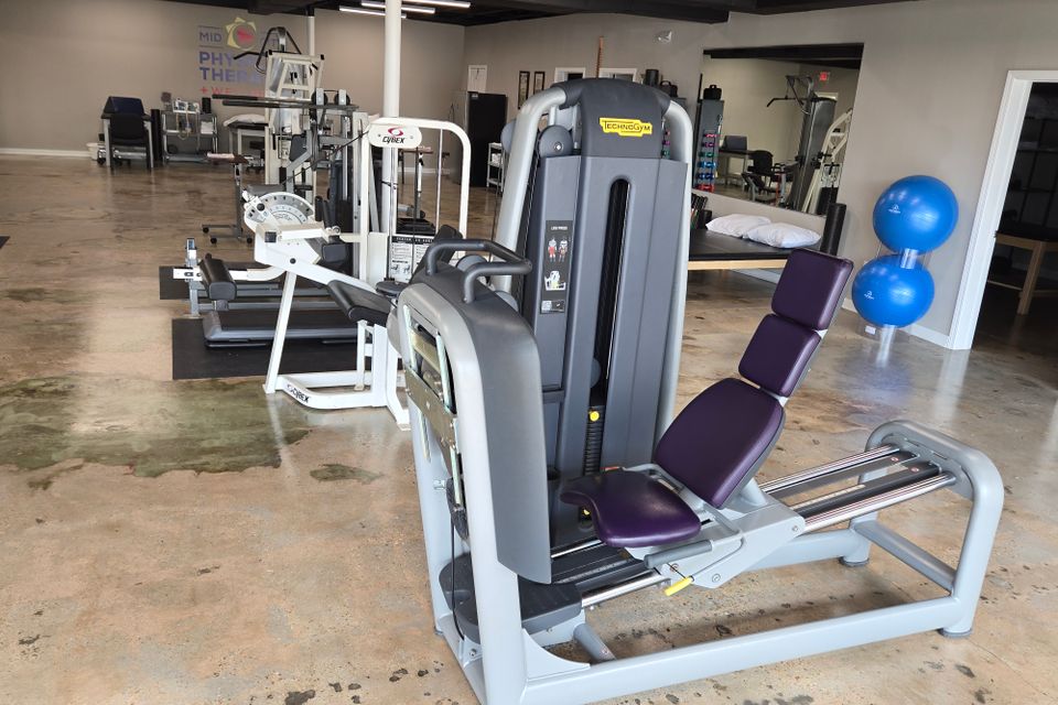 Leg press machine used for lower body rehabilitation at Mid-City Physical Therapy's Metairie clinic