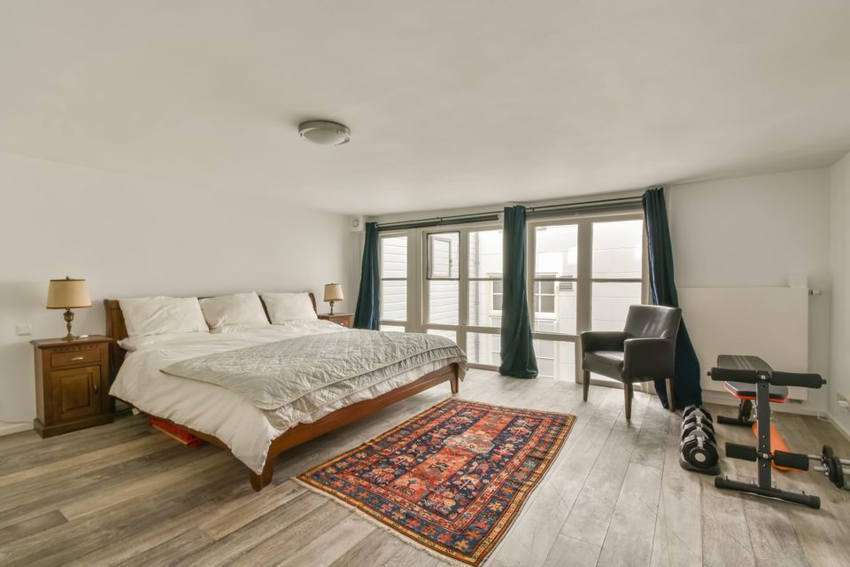 Airbnb bedroom with a bed a desk and a rug 50390343 min