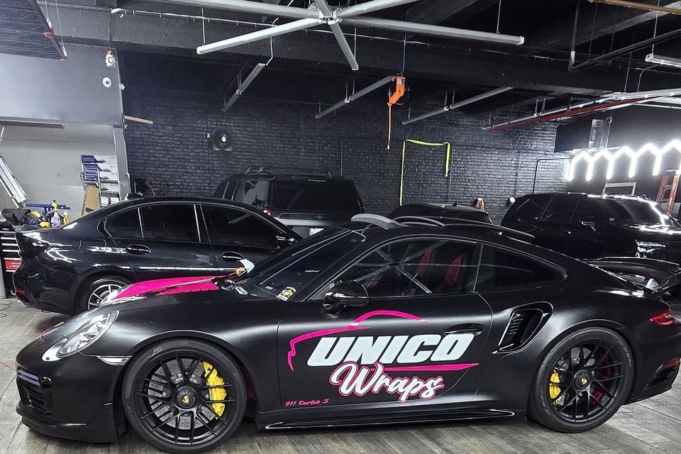 professionally wrapped black car with business name