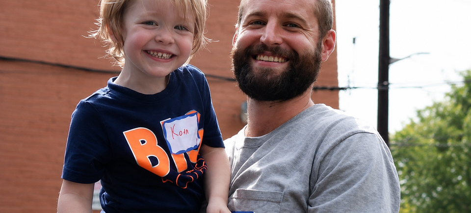 Smiling father and child outdoors