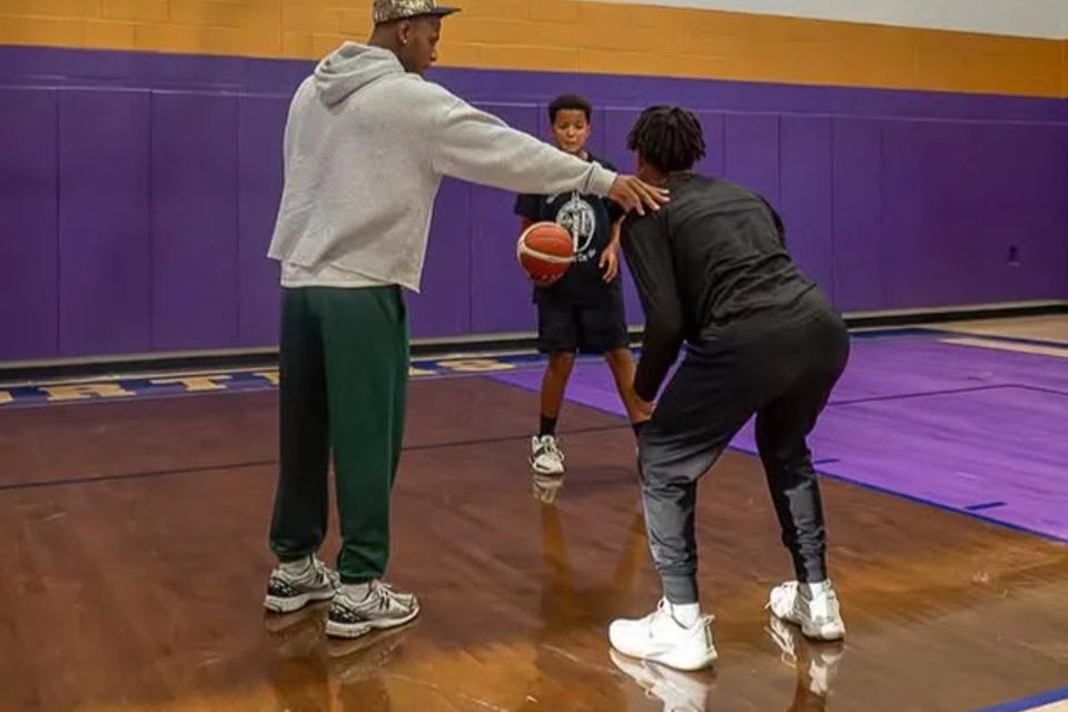 Xavier Allen training someone during practice