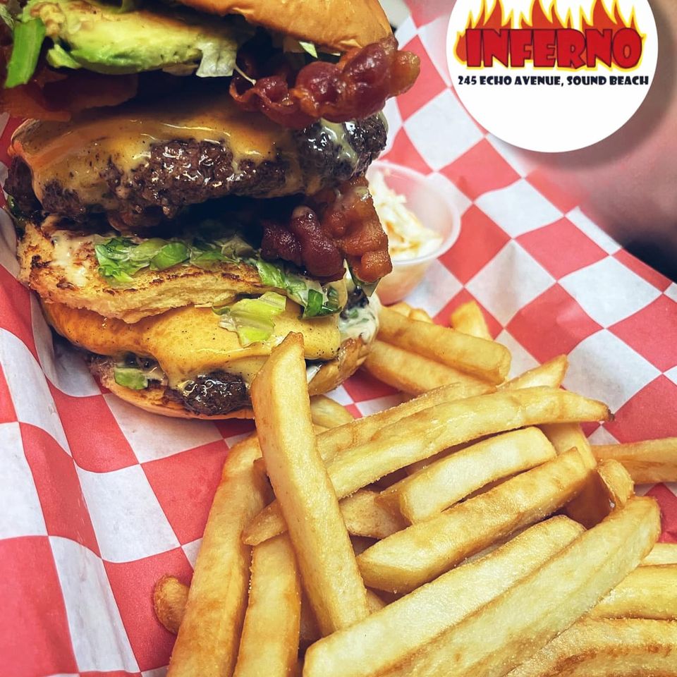 Cheeseburger with avocado, bacon and other toppings with a side of fries at Inferno The Restaurant in Sound Beach