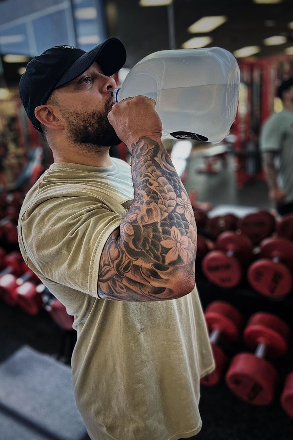 Man drinking pure and refreshing alkaline water gallon bottle