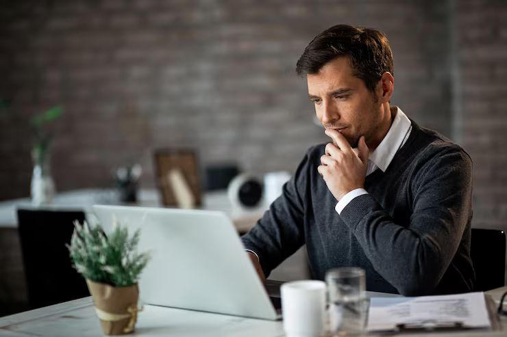 Busy service business owner working at a desk.