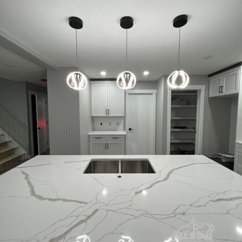 White quartz kitchen countertop with sink and pendant lighting in Houston, TX