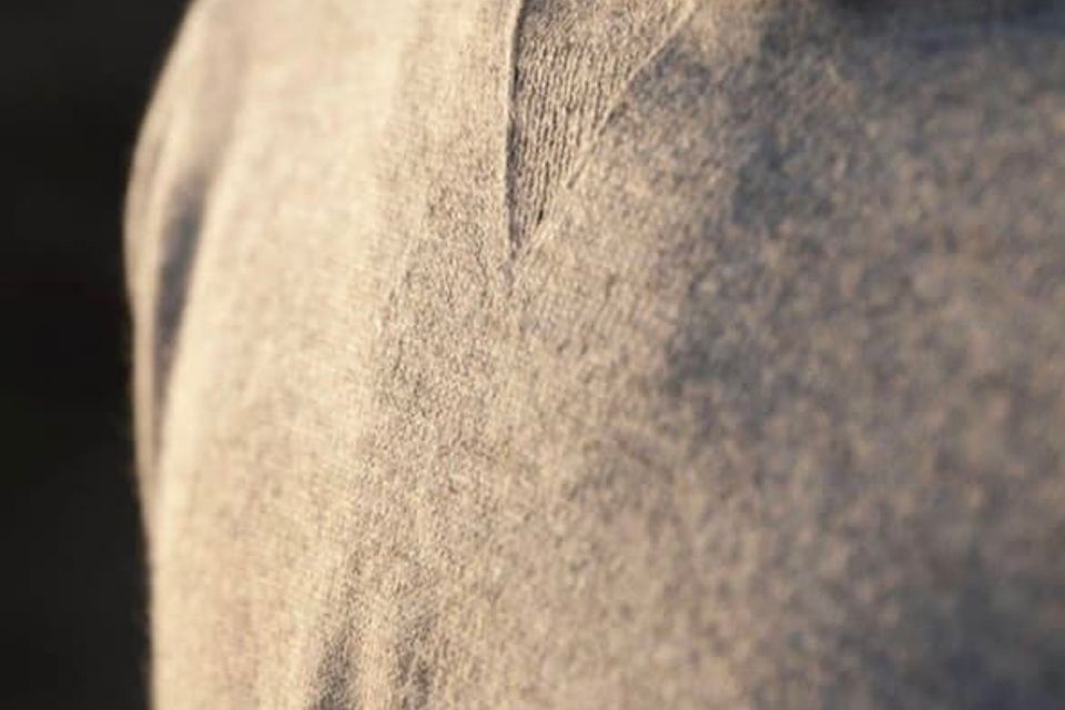 PAKA apparel sweater on a person neck down with great evening light