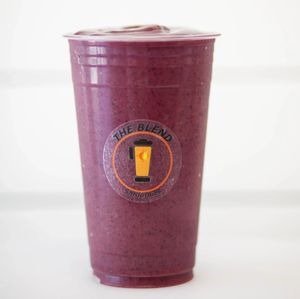 Achieving Açaí smoothie made with apple juice, açaí, banana, strawberries, and blueberries.
