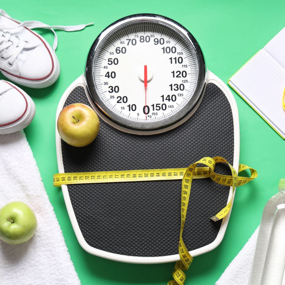 Bathroom scale with measuring tape apples and sneakers representing B-Lean weight management IV therapy