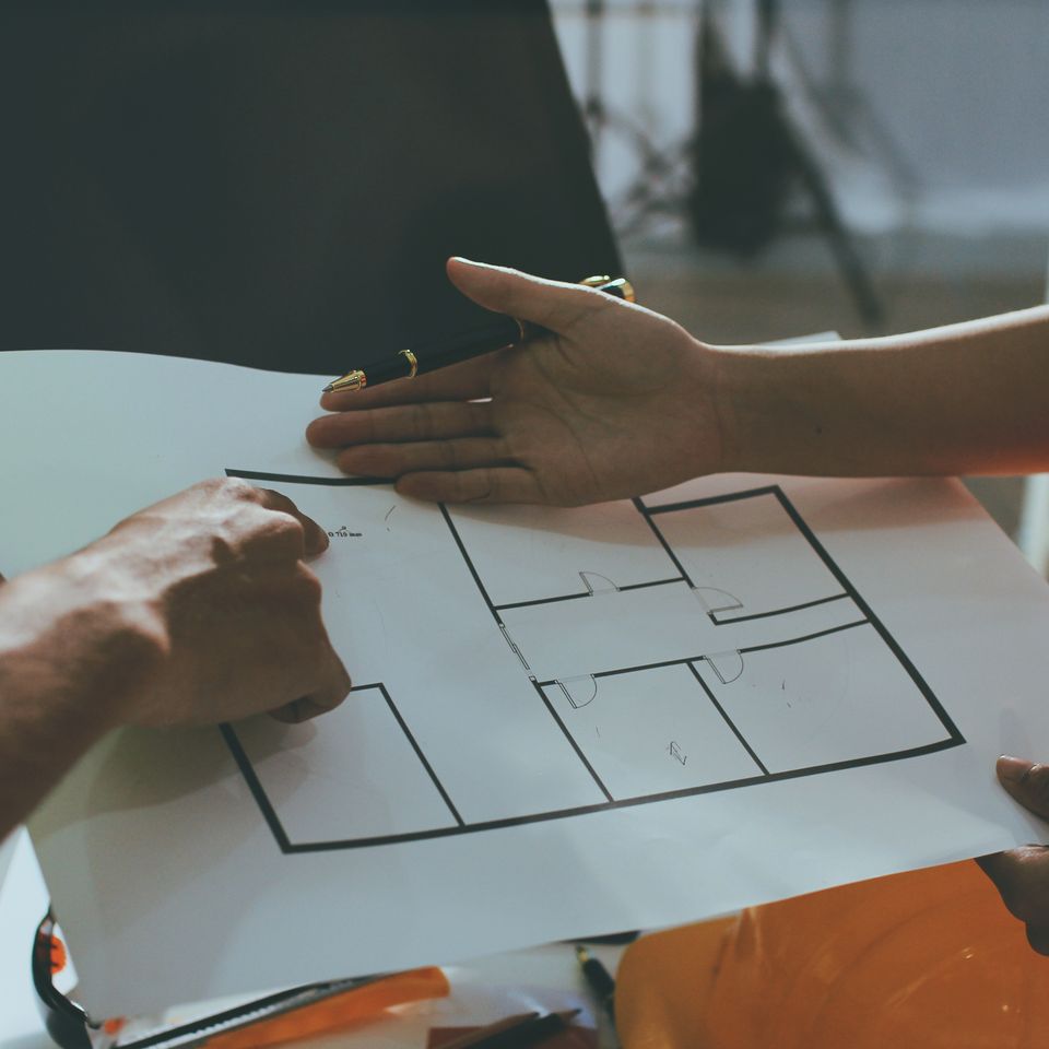 Vecteezy two people are holding a blueprint and drawing on a piece of 71505988