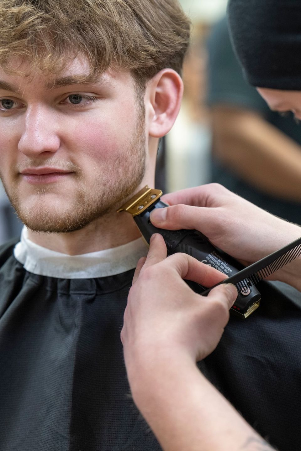 Student providing beard trim service at Jenny Lea Academy