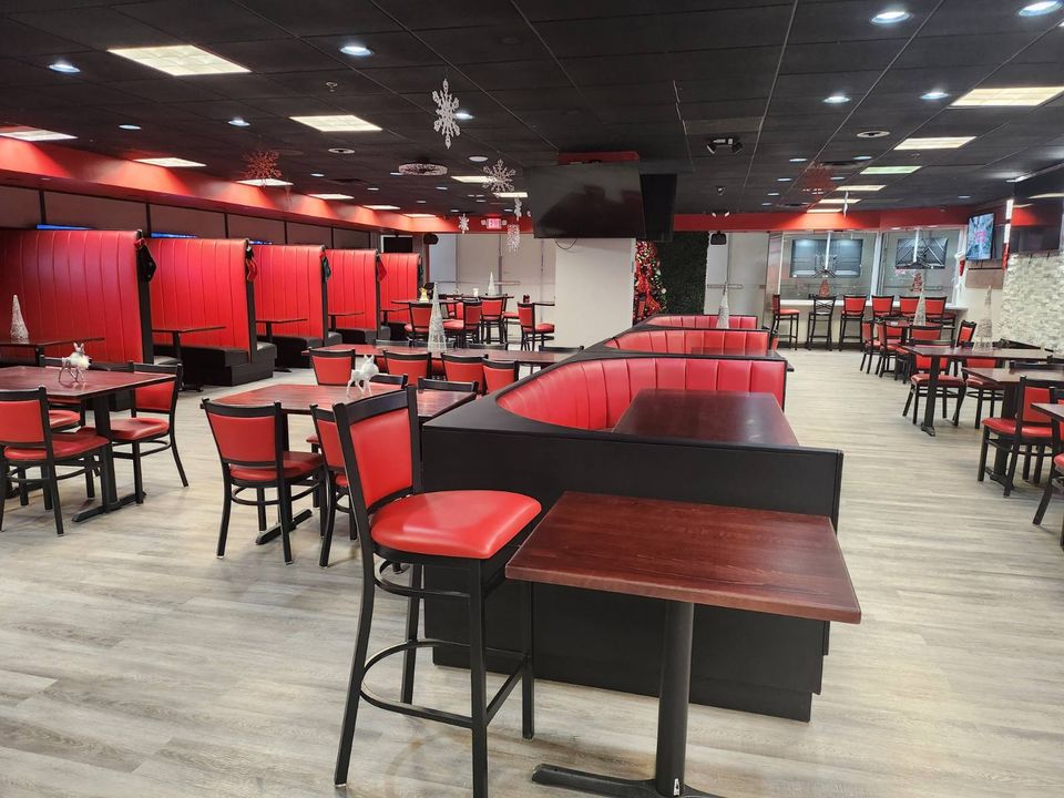 Modern Restaurant Dining Room with Red Booths and Chairs