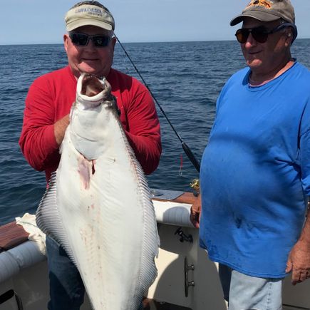 2 men showing off huge flounder