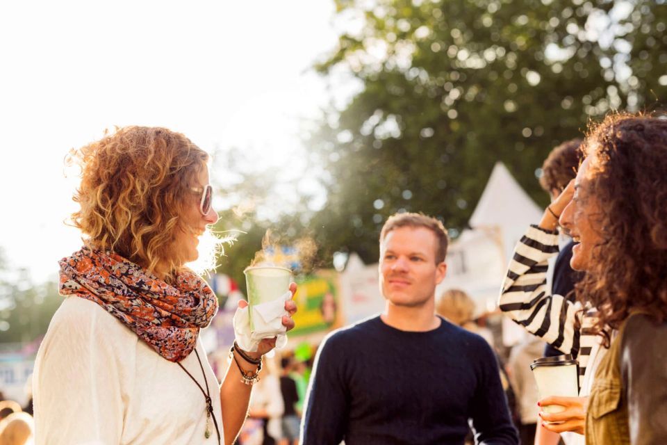 Friends talking and laughing during festival 2024 10 14 17 56 33 utc 2048x1365