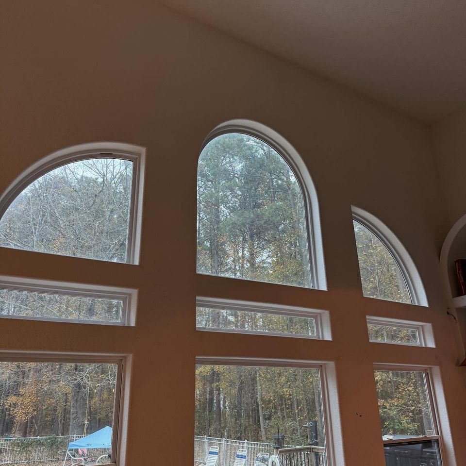 Tall arched living room windows with residential window film installed in a Moyock North Carolina home