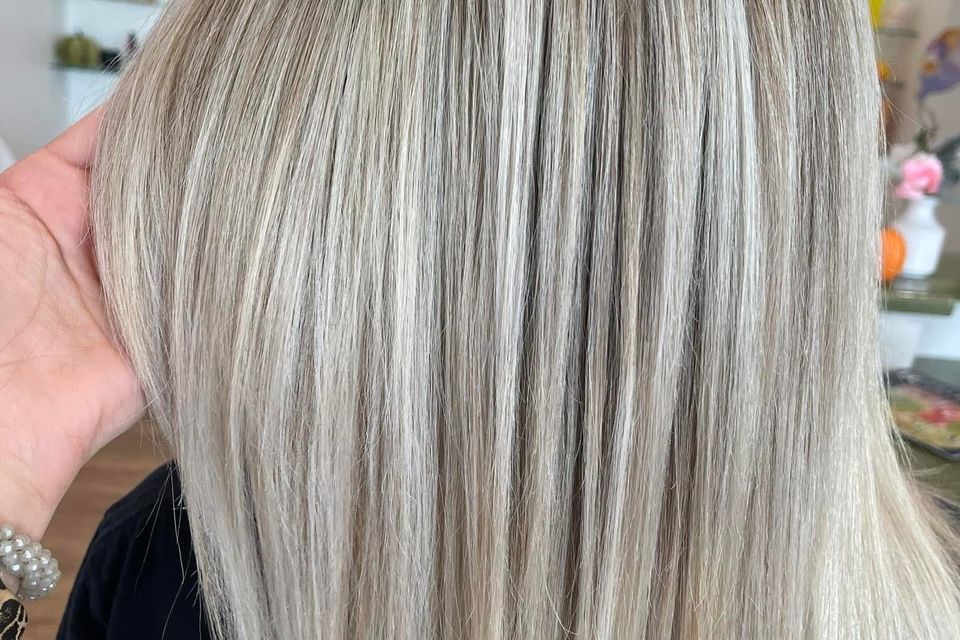 Sleek straight ash blonde hair with dimensional highlights after color service in Columbiana AL