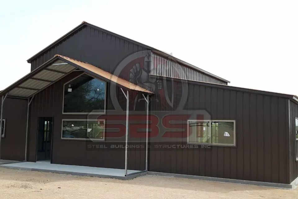 Brown steel building with gabled porch and large windows with SBSI watermark representing steel buildings in Alabama